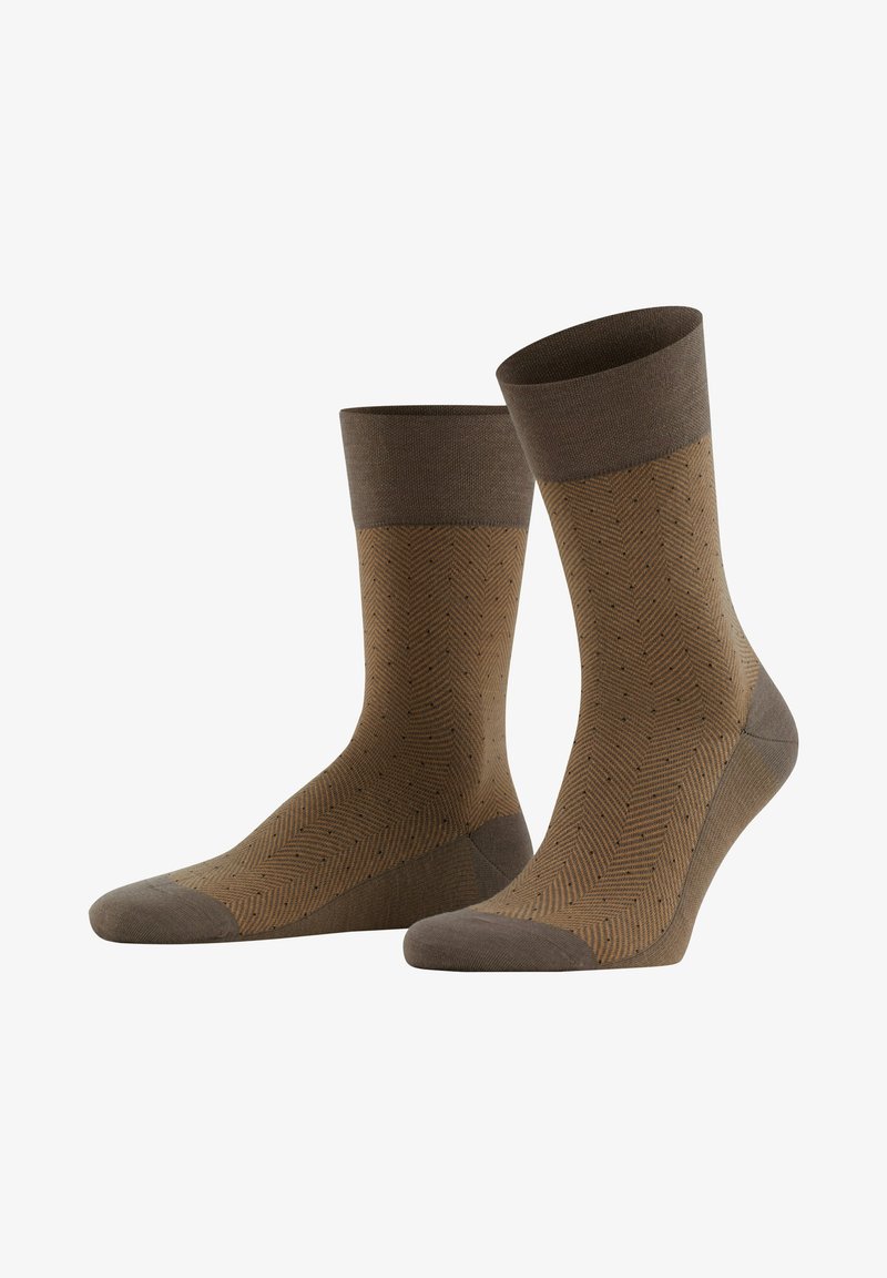 Braun gemusterte Socken mit einem Fischgrätmuster und kleinen Punkten. Sie verfügen über einen einfarbigen braunen Bund und eine verstärkte Zehenpartie für Langlebigkeit.