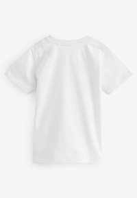 T-shirt en coton blanc, à manches courtes, col rond, construction d'épaules sans couture, texture lisse, conçu pour le confort et la facilité de port.