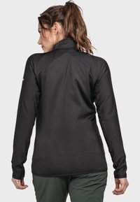Schwarzer langärmeliger Pullover aus strukturiertem Stoff, mit hohem Kragen und Raglanärmeln, von hinten gezeigt.