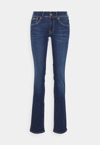 Jean en denim bleu foncé évasés avec une taille mi-haute, cinq poches, des coutures jaunes et un fermoir à bouton à l'avant.