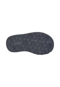 Suela de zapato de goma negra con un patrón de banda de rodadura hexagonal y ranuras para tracción, además de una sección plana rectangular cerca del talón.