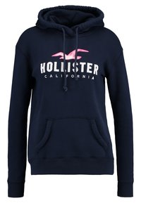 Marinblå hoodie med framficka, snörning och "Hollister California" text under en rosa måslogotyp.