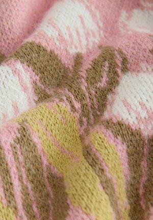 Multicolored knit fabric featuring pink, brown, yellow, and white patterns with a textured, soft finish. Patterns consist of geometric shapes.