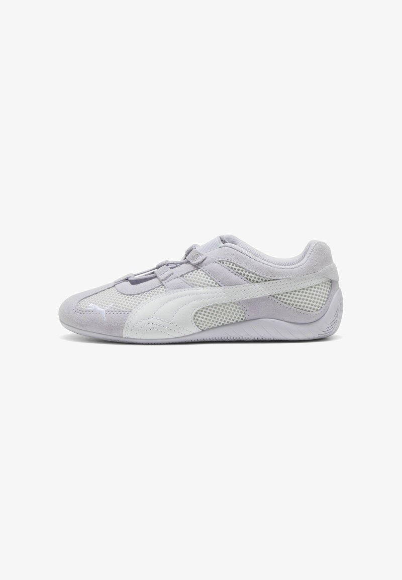 Light grey athletic shoe with suede and mesh materials, rounded toe, contrasting white accents, and textured rubber sole. Adjustable strap for fit.