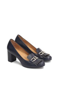 Navy leather block-heeled pumps with a rounded toe, featuring a decorative fringe and metal hardware detail on the front. Smooth texture.