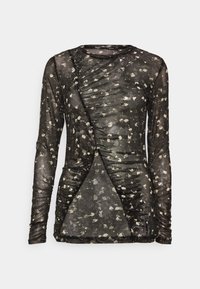 Blusa negra de manga larga hecha de tela transparente, con un patrón floral en color crema, detalles fruncidos y elementos de diseño asimétricos.