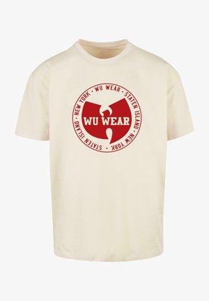 Cream cotton t-shirt featuring a circular red logo with "WU WEAR," "NEW YORK," and "STATEN ISLAND" text in white. Short sleeves, classic fit.