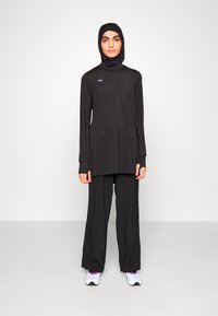 Puma MODEST ACTIVEWEAR WIDE LEG - Treniņtērpa apakšdaļas - black