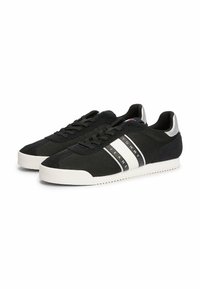 Schwarze Sneaker mit einem Obermaterial aus Mesh und Veloursleder, weißer Gummisohle, drei horizontalen weißen Streifen und silbernen Akzenten an der Ferse.