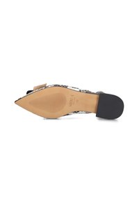 Pointed-toe flat shoe with a black and white snake print pattern, beige sole, and black rubber heel. Smooth texture and minimalistic design.