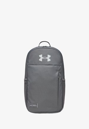 Gray Under Armour backpack with front zipper pocket, top carry handle, side mesh pockets, and visible logos on front panel.