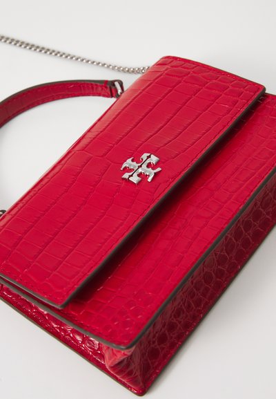 Red crocodile-embossed handbag with a flat design, silver accents, and an adjustable chain strap. Compact with a structured shape.