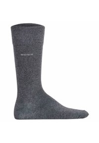 Graue Baumwollsocke mit geripptem Bündchen, nahtloser Zehenpartie und dezenter Markenkennung an der Seite. Glatte Textur und Knöchellänge.