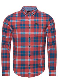 Red and blue plaid long-sleeve shirt with a button-down collar, featuring a left chest pocket and a logo patch on the upper left side.