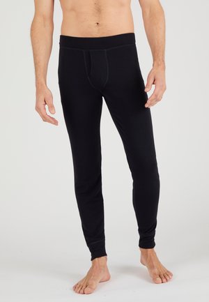 Leggings negros hechos de material elástico, diseño ajustado, con una cinturilla elástica y un bolsillo delantero, que cuentan con una textura suave y sin patrones.