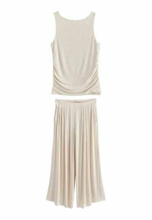 Sleeveless beige top with relaxed fit paired with wide-leg, pleated beige pants, both made of lightweight, soft fabric.