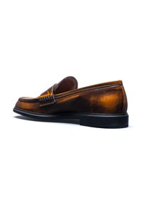 Brown leather loafers with a smooth finish, a low black outsole, subtle stitching, and a decorative band across the upper.