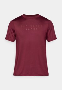 Bordo sportinis marškinėlis, pagamintas iš lygaus, lengvo audinio. Jame yra apvalus iškirpimas ir trumpomis rankovėmis, su nedideliu "TED BAKER SPORT" logotipu.