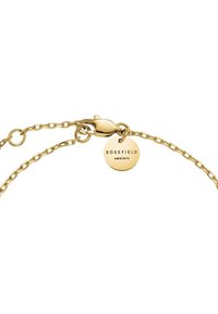 Gold chain bracelet with a lobster clasp and a circular tag engraved with "ROSEFIELD AMS | NYC." Smooth, shiny texture with delicate links.