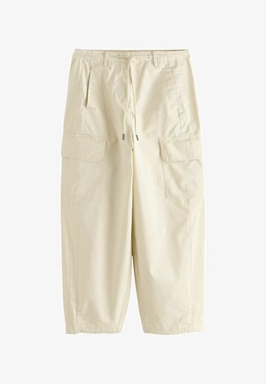 Beige cargo pants with front drawstring, belt loops, side pockets, and large flap pockets on the thighs, made of lightweight fabric.