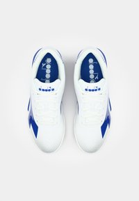 White athletic shoes with blue accents, featuring a textured mesh upper, traditional lacing system, and logo on the tongue and insole.