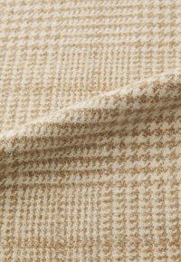Beige and light brown woven fabric with a check pattern, featuring a textured finish and soft drape. Suitable for upholstery or apparel.