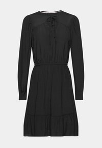 Robe noire avec un col rond, des manches longues, un lien à nouer à l'avant et une taille cintrée qui s'ouvre sur une jupe évasée à volants.