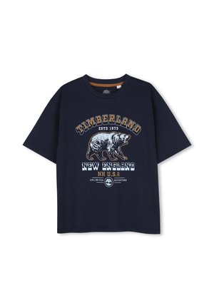 T-shirt Timberland bleu marine avec un graphisme d'ours rugissant et un texte incluant New England, NH États-Unis, et fondé en 1973.