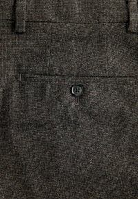 Dark gray woven fabric trousers with a subtle pattern, featuring a rear pocket and a single black button for closure.