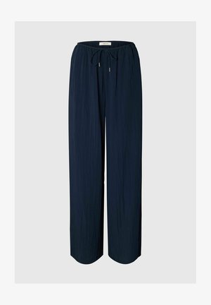 Tumesinised lahtise lõikega püksid, elastse vöökohaga ja reguleeritava nööriga, valmistatud kergest kangast.