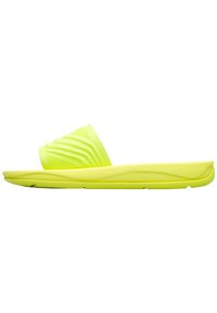 Bright yellow slide sandal featuring a textured strap with grooves, a cushioned sole, and a smooth finish. Lightweight and minimal design.