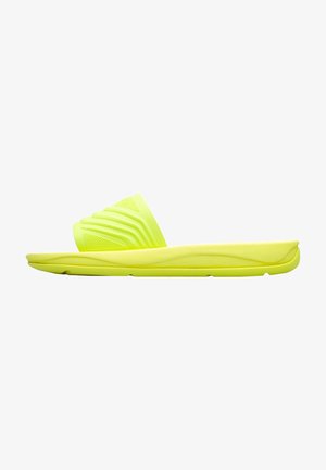 Bright yellow slide sandal featuring a textured strap with grooves, a cushioned sole, and a smooth finish. Lightweight and minimal design.