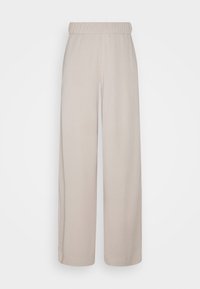 Jasnobeżowe szerokie spodnie z elastycznym pasem, gładką fakturą oraz bez widocznych wzorów czy zdobień.