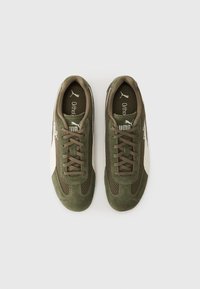 Green suede and mesh athletic shoes with brown laces and a white side stripe. Features a cushioned interior for support.