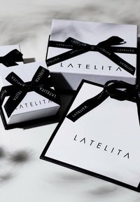 White gift boxes with black ribbon, featuring "LATELITA" logo, varying sizes with a smooth matte texture and sharp edges.