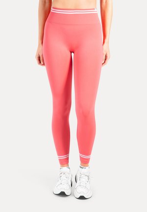 Heldere roze leggings met een geribbelde hoge tailleband. Witte strepen bij de enkel. Soepele, rekbare stof, ideaal voor sportkleding.