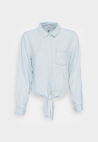 Camicia azzurra chiara, con bottoni e colletto, maniche lunghe e una tasca sul petto, caratterizzata da un dettaglio a nodo legato in vita.