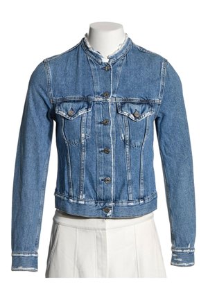 Blå denimjakke med lange ærmer, knaplukning foran, to brystlommer med knapper og en frynset krave på en mannequin.