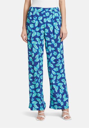 Blauwe wijdvallende broek met een bladerenprint in verschillende groentinten. Het materiaal lijkt lichtgewicht met een gladde textuur.