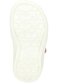 White rubber shoe sole featuring a textured pattern of interlocking hearts and circular shapes. Slightly raised edges and branding detail visible.