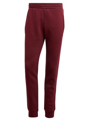 Bordeauxrote, schmal zulaufende Jogginghose mit elastischem Bund, seitlichen Taschen und Bündchen an den Knöcheln, vor weißem Hintergrund gezeigt.