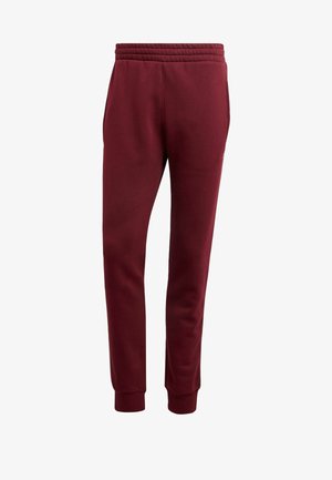 Bordeauxrote, schmal zulaufende Jogginghose mit elastischem Bund, seitlichen Taschen und Bündchen an den Knöcheln, vor weißem Hintergrund gezeigt.