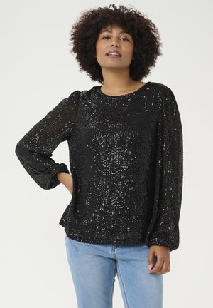 Top negro de lentejuelas con mangas largas y escote redondo. Textura suave y acabado brillante, con detalles de mangas abullonadas y un corte relajado.