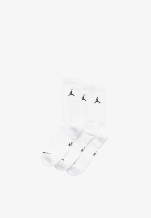 Calzini bianchi in cotone con loghi Jumpman neri. Include tre paia. Design dritto con polsini a costine e suole imbottite.