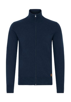 Maglione zip-up blu navy, realizzato in morbido materiale knit, presenta un alto colletto e polsini a coste. Include un piccolo logo etichetta sull'orlo.