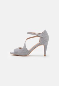 Silver open-toe heeled sandal with a textured upper, ankle strap closure, and a 3-inch stiletto heel. Smooth inner lining.