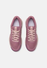 Light purple sports shoes with mesh upper, beige laces and accents, rounded toe, cushioned sole, and logo on the side.