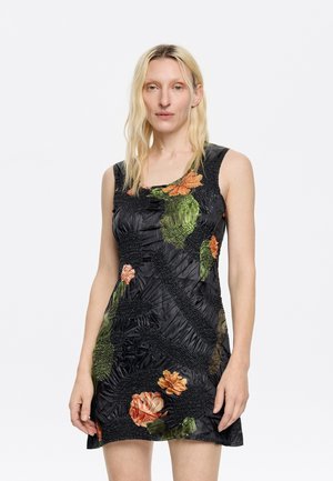 Black sleeveless dress with textured fabric, featuring floral patterns in orange and green across the front. Fitted design with a mid-thigh length.