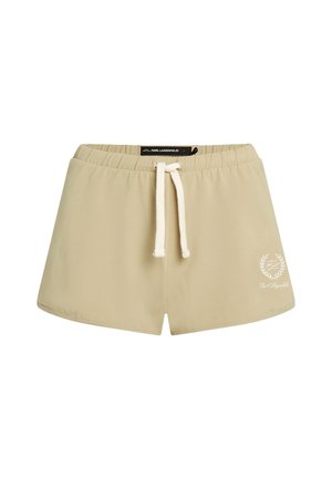 Bežinės medvilninės šortai su elastine juosta, turinčios baltą raištelį ir logotipo detalę apatinėje kairėje pusėje.