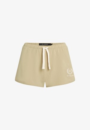 Bežinės medvilninės šortai su elastine juosta, turinčios baltą raištelį ir logotipo detalę apatinėje kairėje pusėje.